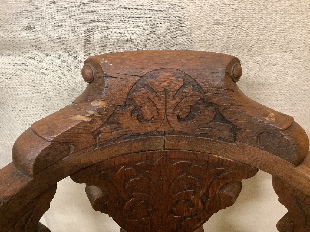 A continental carved oak and cast iron music chair